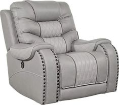 a gray recliner chair with studded trimmings on the arms and back