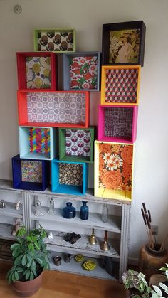 there are many different colored boxes on the shelf next to each other in this room