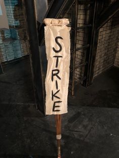 a street sign with the word strike written on it