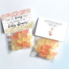 two bags filled with gummy bears sitting on top of a white table next to each other