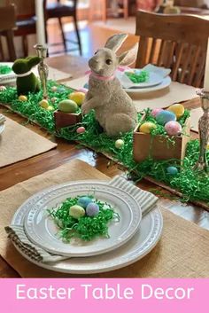 an easter table decorated with grass and eggs