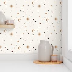 the wallpaper is decorated with stars and moon designs