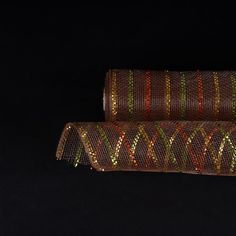 two rolls of decorative string on a black background