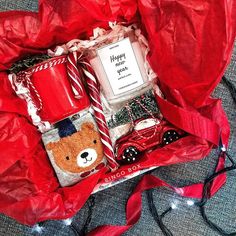 a red bag filled with christmas items on top of a table