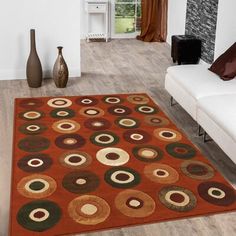 a living room area with a couch, coffee table and large rug on the floor