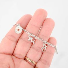 Discover charm and elegance with our 925 Sterling Silver S Curb Link Chain and Multiple Charms Bracelet. Adorned with delightful Chinese coin, Snoopy, heart, and apple charms, this bracelet exudes personality and style. Perfect for adding a playful touch to any outfit or as a meaningful gift for someone special. Elevate your look with this unique and versatile piece today.Bracelet length: 6inChain style: Chain S linkWeight: 7gFor more of our jewelry products, please visit our shop 777jewelryLA F Dainty Silver Charms With Removable Features, Dainty Silver Charms With Removable Feature, Dainty Silver Charm Bracelet With Dangling Charms, Sterling Silver Charm Bracelet With Heart Dangle, Sterling Silver Charm Bracelet With Removable Charms, Sterling Silver Charm Bracelet With Removable Dangle Charms, Sterling Silver Dangle Charm Bracelet With Removable Charms, Silver Charm Bracelet With Heart Charm, Hypoallergenic Dangle Charm Bracelet In Sterling Silver