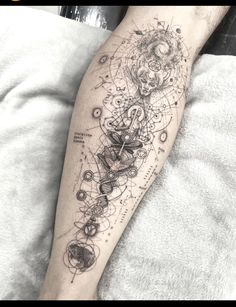 a person with a tattoo on their leg that has an image of a clock and other things