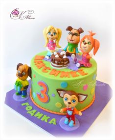 a birthday cake decorated with cartoon characters on top of it, and the number three is 3