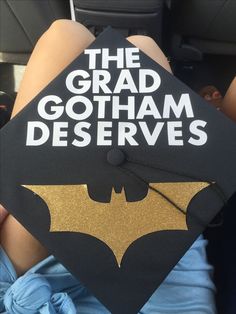 a black and gold graduation cap that says the grad gotham deserves