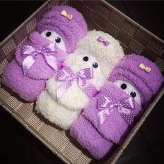 four purple and white teddy bears in a basket