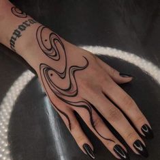 a woman's hand with black and white designs on it