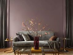 a living room with purple walls and furniture