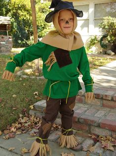 a little boy dressed up as a scarecrow