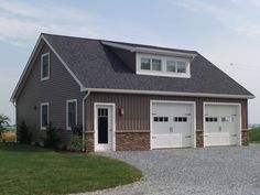 a two car garage with three windows on the top and one door open to let in light