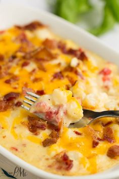 a fork in a casserole dish with bacon and cheese