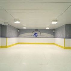 an empty ice rink with yellow and white lines