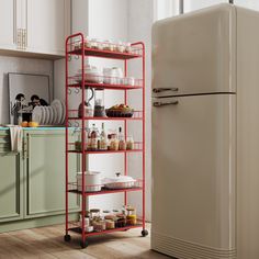 a kitchen with an old fashioned refrigerator and red shelving unit in the middle of it