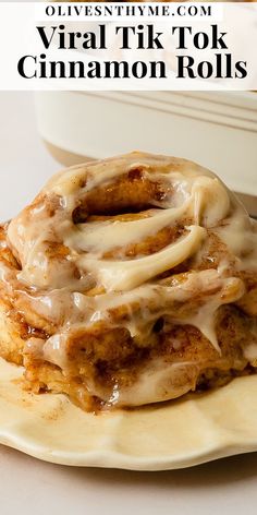 a stack of cinnamon rolls sitting on top of a white plate