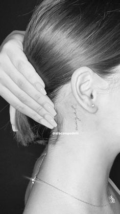 a woman with a small tattoo on her neck