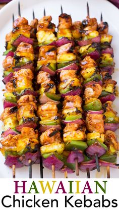 hawaiian chicken kebabs on a white plate with the title above it in red and green