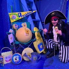 a man dressed as a pirate with bananas and other items on display in front of him