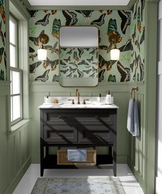 a bathroom with two sinks and a large mirror above the sink is decorated in floral wallpaper