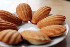 there are many cookies on the plate and one is half peeled, some have been cut in half