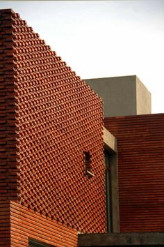 a red brick building with a clock on it's side