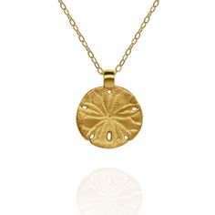 Gold vermeil Sand Dollar charm pendant and chain. This charm measures 1.5cm in diameter, which is 0.63 inches, and is hung from an 18” chain. It has been made using genuine gold vermeil. The correct definition of ‘Gold Vermeil’ is solid Sterling Silver that has been coated with a minimum of 2.5 microns of gold. Wearing a piece of Adrian Ashley’s jewellery identifies you as someone who can appreciate handmade goods and fine craftmanship. I do my best to insure all the raw materials I use have been sourced responsibly and I always price my work honestly. All pieces are handmade in a small workshop in the English countryside and shipped to collectors across the world. Prized by beach combers, sand dollars are often treasured mementos of a tropical holiday.Sand dollars are relatives of starfis Gold-plated Yellow Gold Charm Necklace With Round Pendant, Yellow Gold Plated Charm Necklace With Round Pendant, Gold Plated Yellow Gold Charm Necklace With Round Pendant, Yellow Gold Brass Medallion Charm Necklace, Yellow Gold Brass Amulet Charm Necklace, Yellow Gold Brass Amulet Charm Necklaces, Gold Charm Necklace With Round Pendant And Cable Chain, Yellow Gold Medallion Necklace With Large Pendant As Gift, Yellow Gold Medallion Charm Necklace