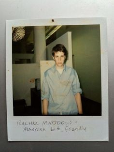 a polaroid photograph of a young man in a blue shirt