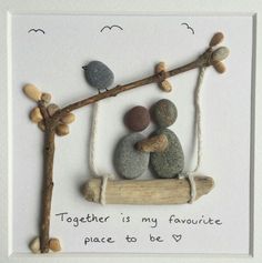 two pebbles are sitting on a tree branch with the words together is my favorite place to be