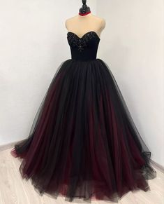 a black and red ball gown on a mannequin