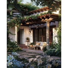 an outdoor living area with white furniture and flowers