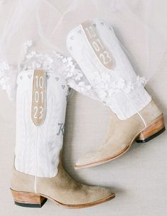 the cowboy boots are decorated with white flowers and lace on them, along with a veil