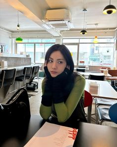 a woman sitting at a table in an office