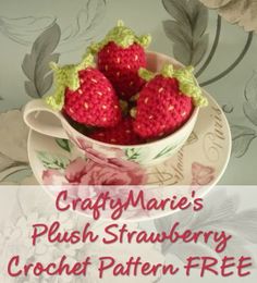 crocheted strawberries in a teacup with the words crafty marie's plush strawberry crochet pattern free