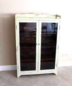 a white cabinet with glass doors in a room