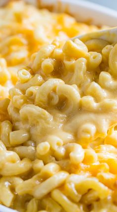 the words cooking are written on top of macaroni and cheese