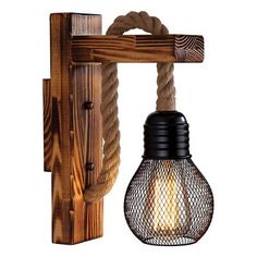 a light that is on the side of a wooden wall mounted fixture with rope attached to it