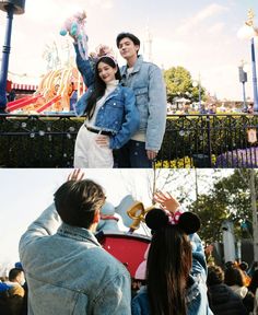 a couple standing next to each other in front of a carnival