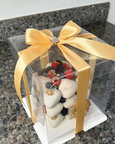 a clear box filled with lots of different types of candies and chocolates on top of a counter