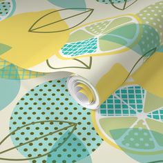 a wallpaper with green, yellow and blue leaves on the background that is made up of polka dots