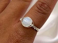 please note you will need to size up from your original ring size as the bands on my rings are on the thicker side  Save when you shop through my website, I'd appreciate it 💚- https://shorturl.at/dGU49 Lovingly handmade wire wrapped crystal rings 🔮💘 💓 October Birthstone OPALITE - imitation Opal  Increase your inner belief and become the best version of yourself with these Opalite pendants. 💫 Though a synthetic stone, Opalite still holds intense energy. 💫 Helps to spread light & encourages Wrapped Rings, Jewellery Ring, Handmade Jewelry Ring, Wrapped Crystal, Rings Unique, Wire Wrapping Crystals, Handmade Wire Wrapped, Wire Wrapped Rings, October Birthstone