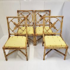 four bamboo chairs with yellow cushions on white floored room area, side by side