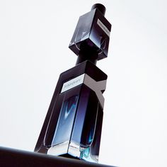 the perfume bottle is stacked on top of each other in front of a white background