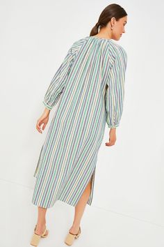 Equal parts effortless and elevated, the Zephyr Stripe Heidi Dress is a warm-weather staple. The straight, maxi silhouette boasts long blouson sleeves with button cuffs, a partial front button placket, and side slits for easy movement. Pair with sandals and a tote or elevated with heels and a clutch! Round neckline Gathering along neckline Long blouson sleeves with button cuffs Partial front button placket Relaxed straight silhouette Side slits Maxi length Material: 100% Cotton Care: Hand wash c Spring Daywear Maxi Dress With Elastic Sleeves, Long Sleeve Dresses With Side Slits For Daywear, Bishop Sleeve Maxi Dress For Daywear, Long Sleeve Maxi Dress With Side Slits For Daywear, Long-sleeved Maxi Dress With Gathered Sleeves For Vacation, Spring Long Sleeve Maxi Dress With Side Slits, Long Sleeve Maxi Dress With Gathered Sleeves For Vacation, Cotton Maxi Dress With Long Sleeves For Brunch, Long Sleeve Midi Dress With Gathered Sleeves For Vacation