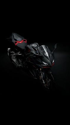 a black motorcycle is shown in the dark