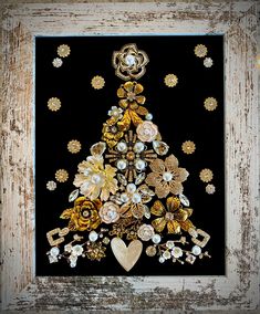 a decorated christmas tree made out of buttons and other decorative items on a black background