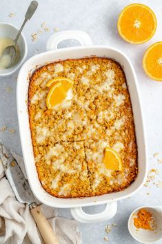 a casserole dish filled with oranges and crumbled oatmeal