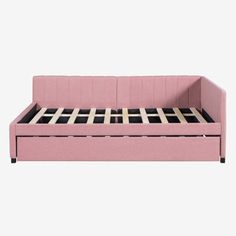 a pink sofa bed sitting on top of a white floor